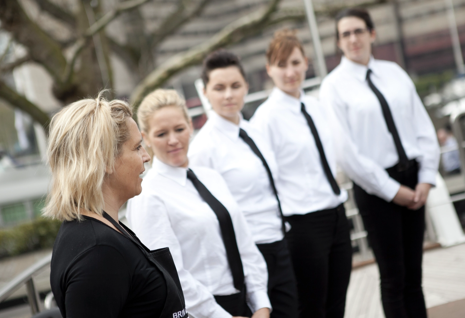 Yacht crew receiving onboard service training from instructor to improve service standards and consistency