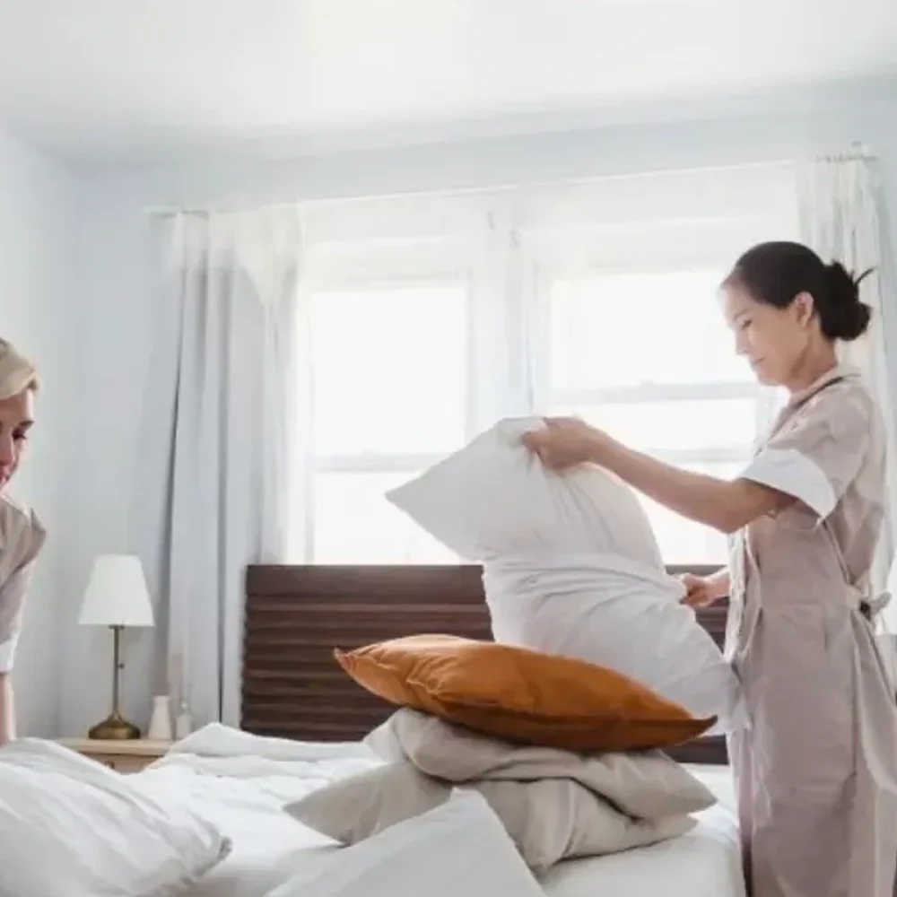 two-housekeepers-making-bed