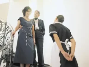 Housekeeper interacting with homeowners inside a private residence