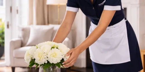 Housekeeper arranging flowers